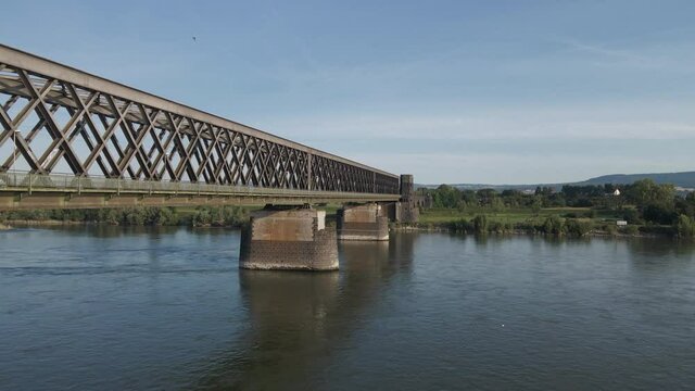 Flying beside and over the Truss-design Urmitzer Railway Bridge, Rhine river, Germany