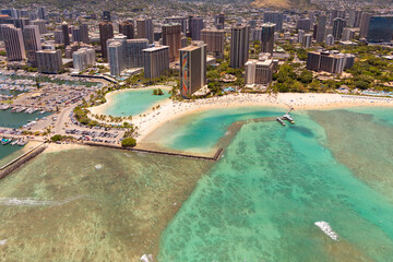 Aerial view of Waikiki Beach, Oahu, Hawaii. Turquoise blue water bordered by golden sandy beaches and hotels.  