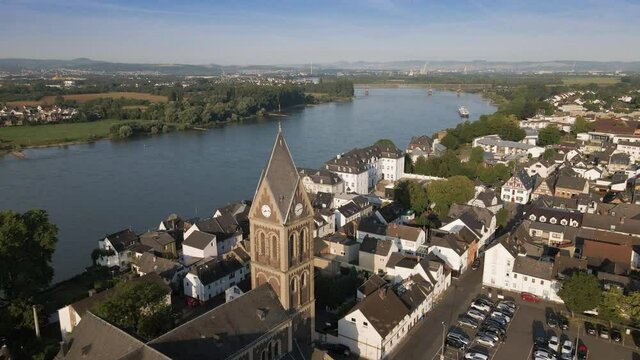 Drone flight past St. Martin (Engers) Church, towards Engers Castle on Rhine river, Germany