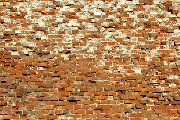 Texture of an old brick wall. Chipped bricks.