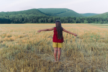 Side view portrait of happy beautiful girl breathing fresh air in field, outdoors. High quality photo