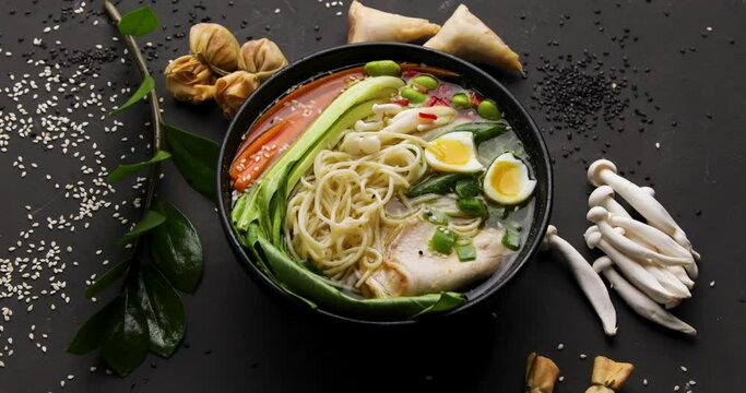 Asian soup ramen on black background.