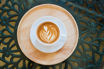 hot latte art coffee on wood table, relax time
