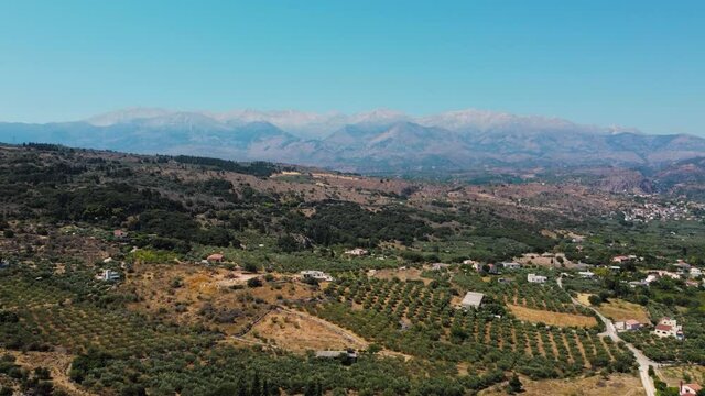 Drone flying over Cretan countryside and Lefka Ori Mountains - Crete - Greece.