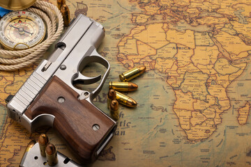 Semi automatic hand gun with bullets on global vintage map , Can be used as a background