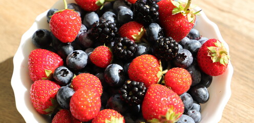 lots of fresh blueberries, strawberries and blackberries as a background
