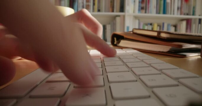close up hands typing on keyboard in home office student studying browsing online sending messages working from home