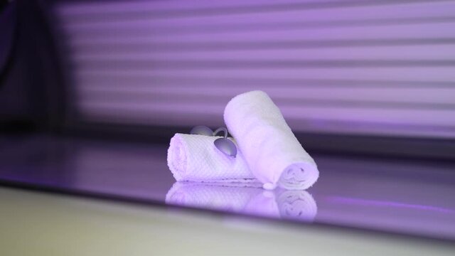 purple solarium cabin with towels on top.