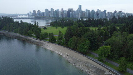 View of Downtown Vancouver from the air with Stanley Park in the foreground. Taken over Burrard Inlet on a cloudy rainy day
