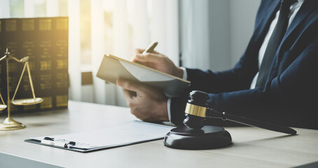 Lawyer hand holding pen and providing legal consult business dispute service at the office with...
