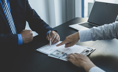 Government officials hand sign the contract for receiving bribe money from businessman, the concept...