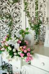 Wedding decor with bouquet on the table. White spring decoration.