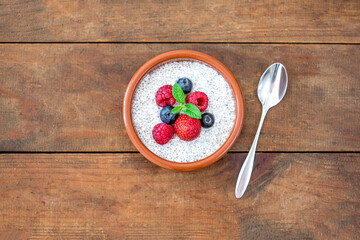 Chia seed pudding made with fruits and fresh  berries over wood background. Chia seeds Yogurt.