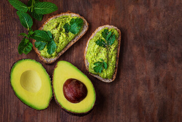 Avocado toasts on a wooden background
