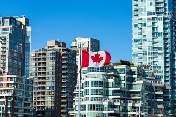 National Flag of Canada with downtown Vancouver City condominium apartment in the background....