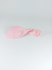 An uninflated pink balloon.