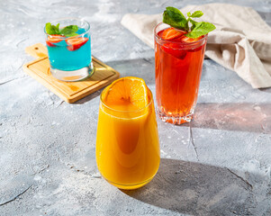 different refreshing fruit cocktails on the table