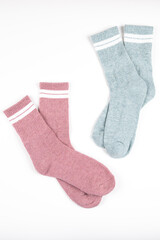 Two pairs of warm socks insulated on white. Pink and gray socks on white