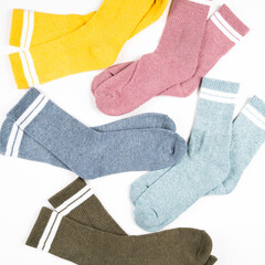 Warm multi colored women's socks with stripes isolated on white, top view