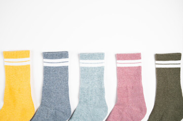 Close up of multi colored women's socks with stripes isolated on white, top view