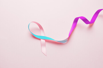Colorful ribbon on pink background. Thyroid cancer awareness concept