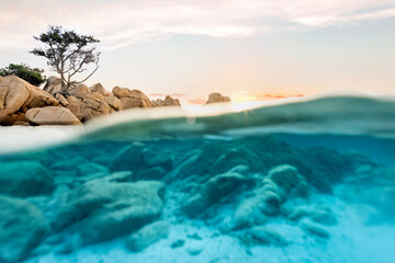 (Selective focus) Split-shot, over-under shot. Half underwater half sky with turquoise sea and a...