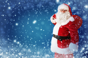 Naklejka na ściany i meble Santa Claus with bag full of gifts on color background