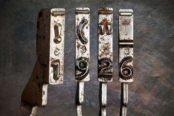 vintage old typewriter hammers with the date 1920  with vintage wallpaper background