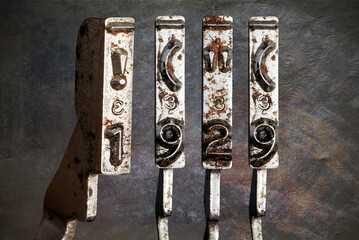 vintage old typewriter hammers with the date 1920 wit vintage wllpaper background