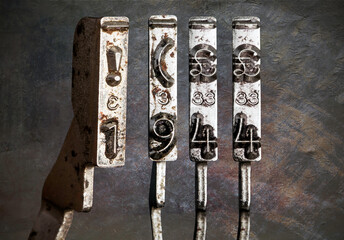 vintage old typewriter hammers with the date 1944 with vintage wallpaper background