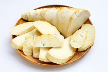 Bamboo shoots in wooden plate on white background