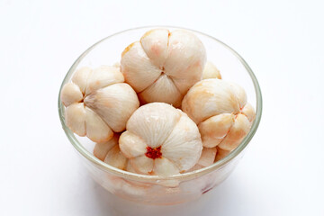 Mangosteen in glass bowl on white background.