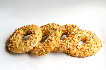 Close-up of four homemade Peanut Cookie Rings on a light background. Crunchy delicious cookies with nuts.