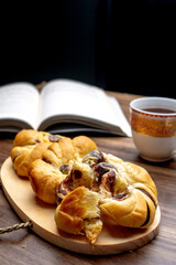 red bean bread, roti kacang merah, indonesian dish with a cup of tea and a book in the background