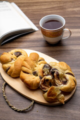 red bean bread, roti kacang merah, indonesian dish with a cup of tea and a book in the background