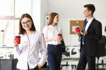 Businesswoman drinking coffee in office