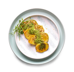 Grilled potato and zucchini with pesto sauce on white background