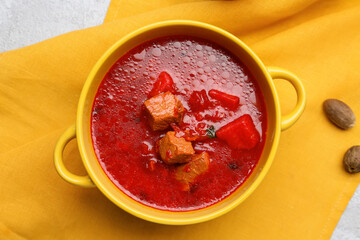 Pot with tasty borscht on table