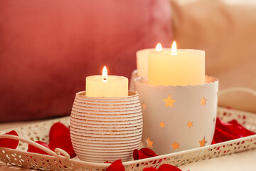 Tray with beautiful burning candles on table, closeup