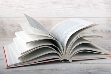 an open book lies on a white wooden table