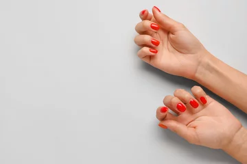 Foto op Plexiglas Female hands with beautiful manicure on light background © Pixel-Shot