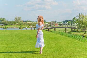 Lady in white cotton suit, crop top and skirt at nature, vacation scene