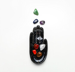 Composition with set of chakra stones on white background