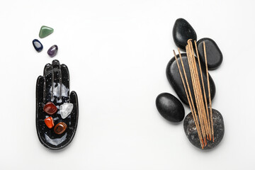 Composition with set of chakra stones and incense on white background