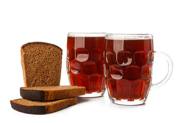 Mugs of fresh kvass and bread on white background