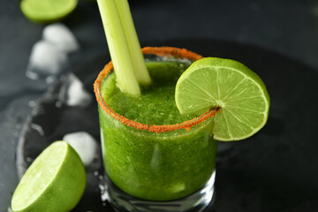 Glass of bloody Mary cocktail on dark background