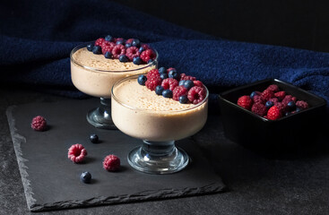 Ryazhenka mousse in glass bowls decorated with fresh berries
