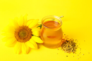 Jar of honey on color background