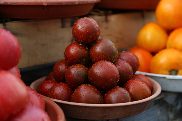 Black tomatoes selling on local farm market, eco vegetables, juicy products. Shopping organic products. Healthy grocery
