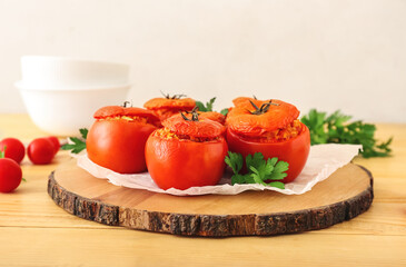 Board with tasty stuffed tomatoes on wooden background